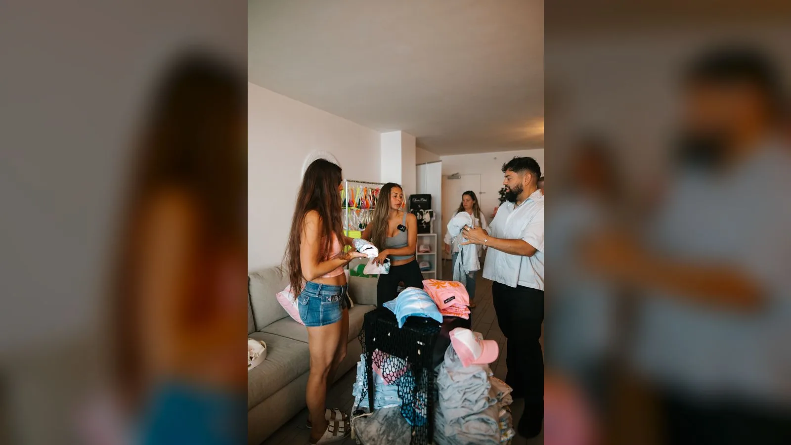 Creators sorting and packing CI Swimwear together in a sunlit apartment ahead of Swim Week