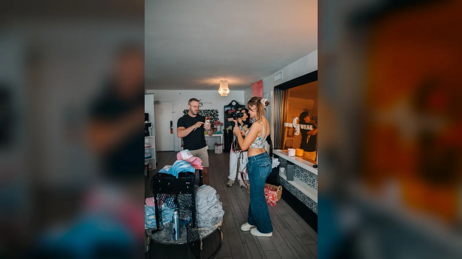 Creator posing while being photographed during an event at the CI Swimwear showroom