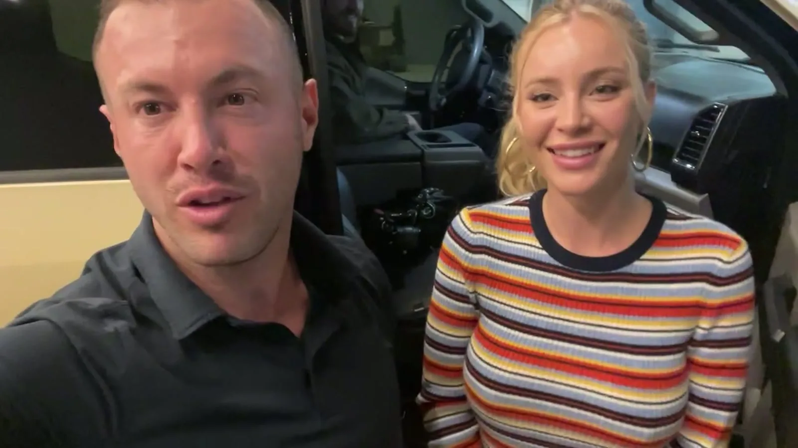Founder Andy speaking to camera beside a smiling creator in a striped sweater inside a vehicle